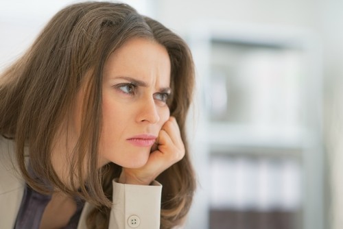 Portrait of frustrated business woman sitting in office